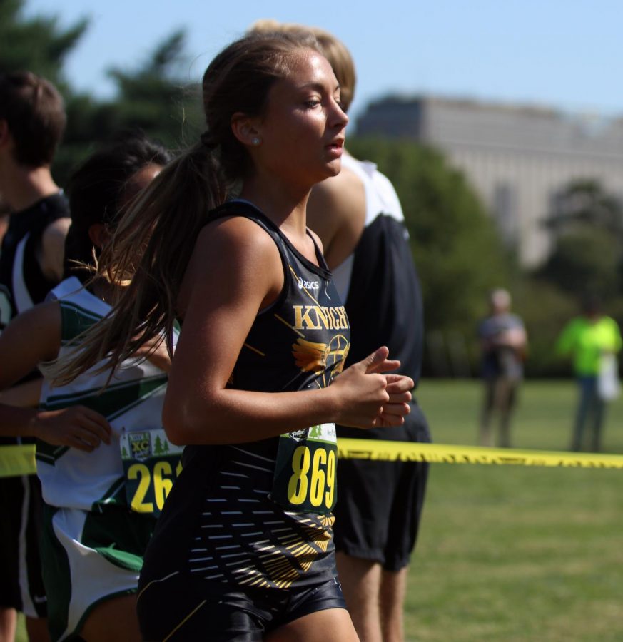 Senior Maggie Hillmann runs in a varsity cross country meet for FHN. 