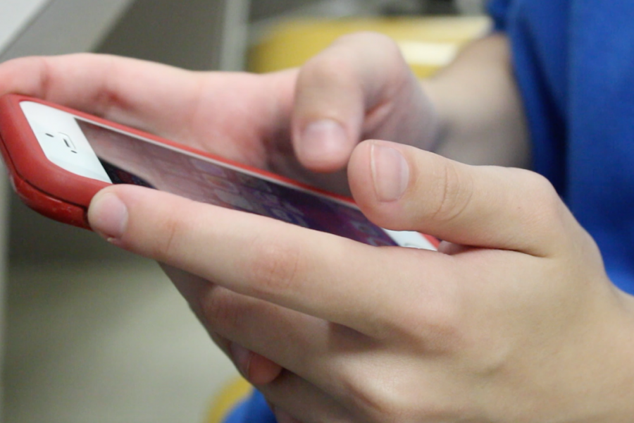 Freshman Ethan Chankin plays on his phone during class. Cell phones are often considered a distraction but have been found to be very useful.