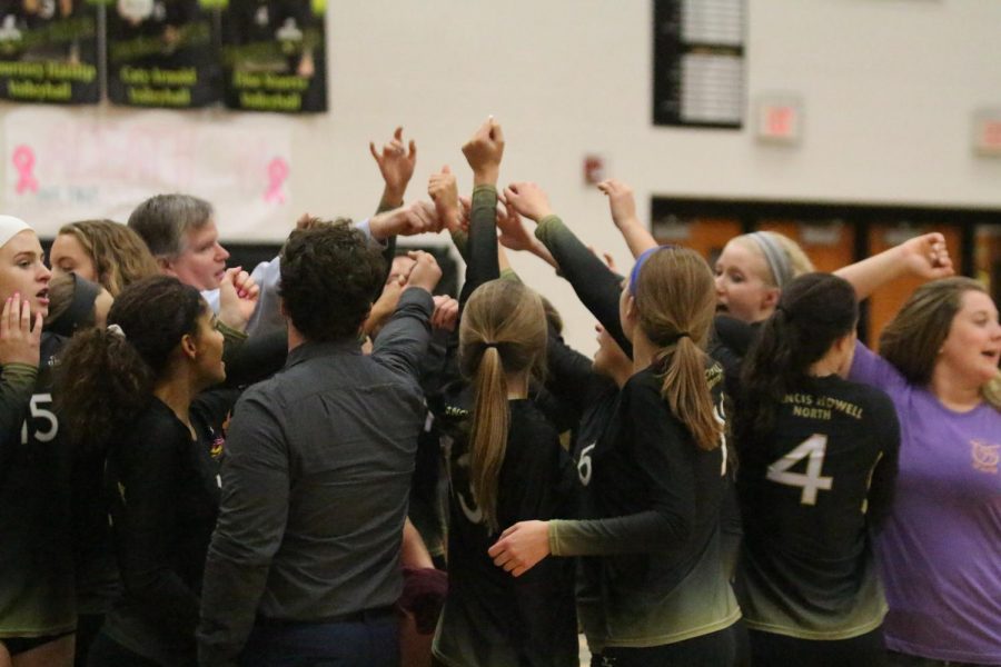 Howell North's varsity girls volleyball team huddles up during a timeout on 9/26 vs. FHC.