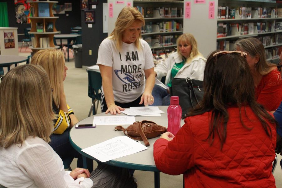 The craft committee sits down to discuss the upcoming meeting for their annual craft fair. The committee is in charge of planning the fair every year.