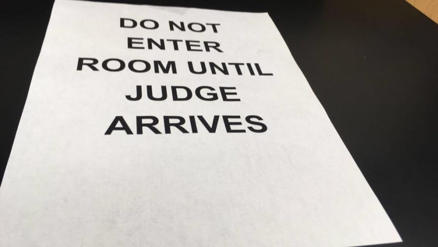 At the Speech and Debate tournament, signs were hung around the school to inform competitors of rules. (file photo)