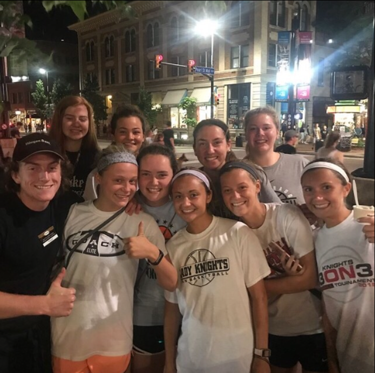 Members of the team pose with a Ben & Jerry's worker on Pearl Street