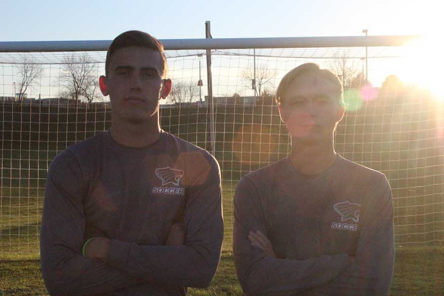 Alumni Michael Scanlon and Anthony Kristensen stand together in front of the net at St. Charles Community College. 