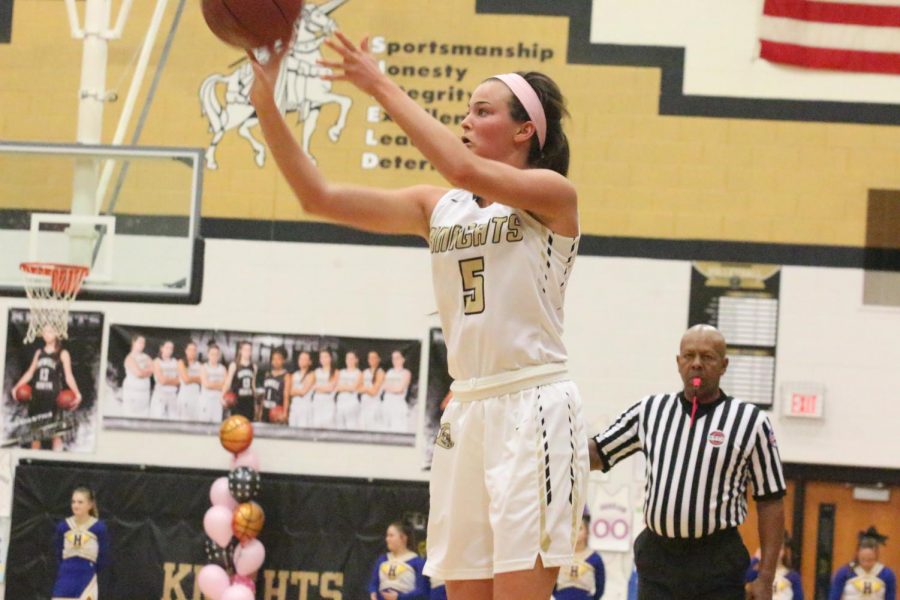 Junior Gabby Delarue attempts a shot in a varsity basketball game in the Howell North gym.