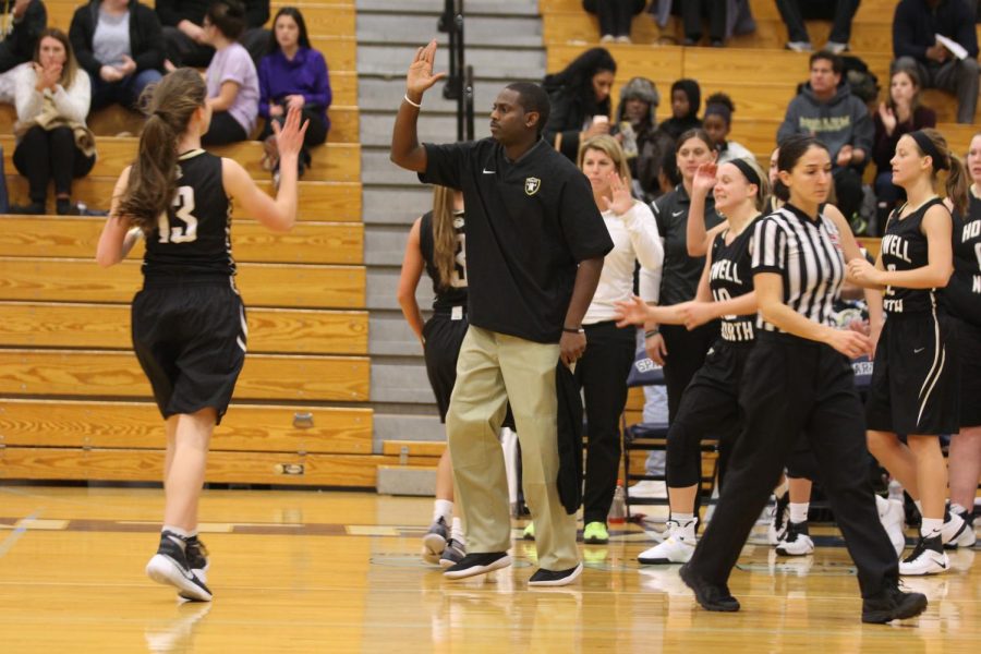 Former varsity girls basketball head coach Jamal Thompson embraces one of his players in a road game vs. Francis Howell Central on 12/16. 