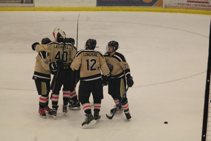 The hockey team, with Blaine Longmore as number 12, huddles together after scoring a goal against the Francis Howell Vikings during the 2017 Gold Cup. The game is an annual event between the two teams taking place early in the season. The Knights would eventually drop the game 8-2. The matchup will happen two more times this regular season on Dec. 9 and Dec. 29.  