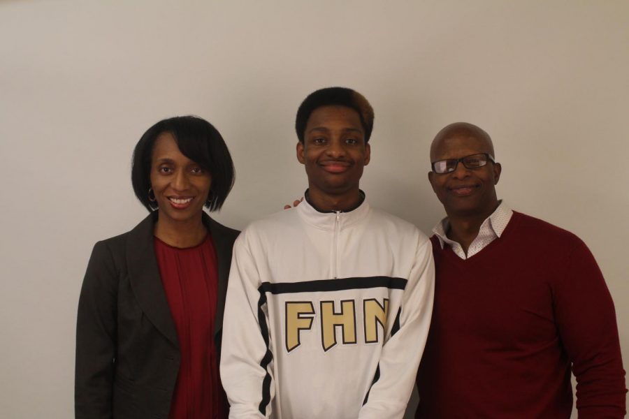 Tyler Haynes poses with his mother Tonya Haynes and father Teron Haynes. He has worn number 32 since his freshman year. 