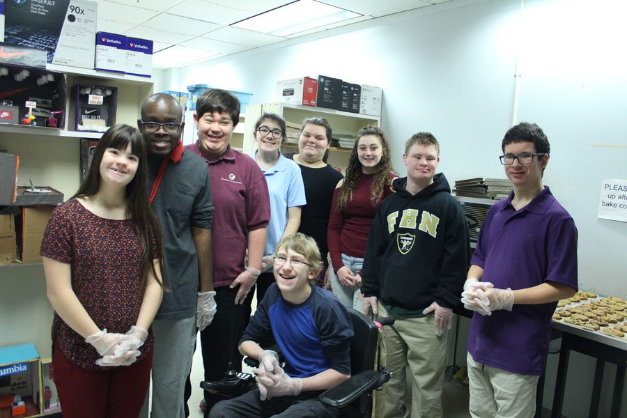 Some of the students involved in baking DECA cookies pose for a group photo. 