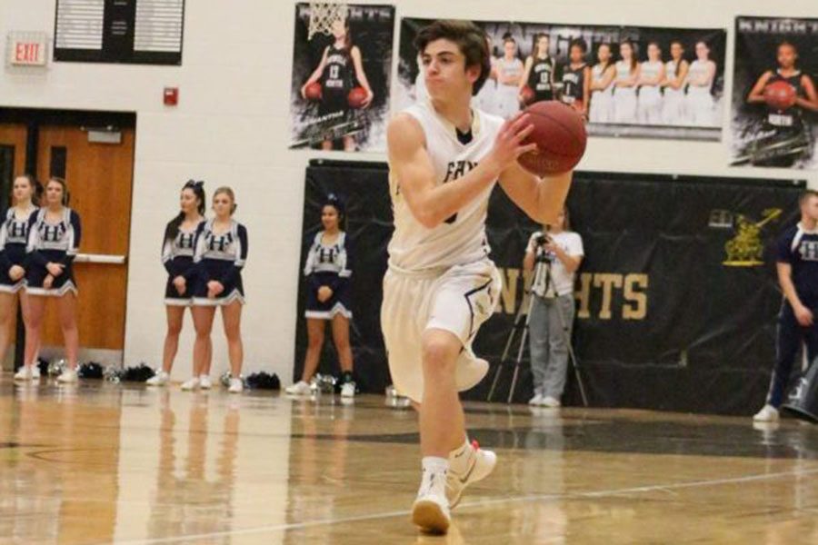 Junior Drew Scheer takes possession of the basketball in a Knights varsity basketball game in the Howell North gym.