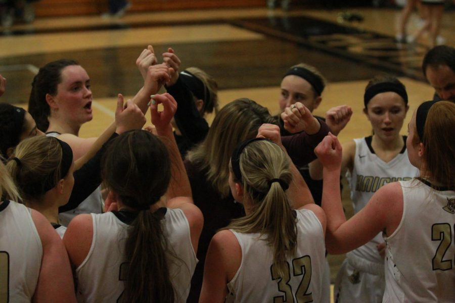 The varsity girls Lady Knights basketball team huddles for a time out in the Howell North gym on 1/16 vs. Timberland.