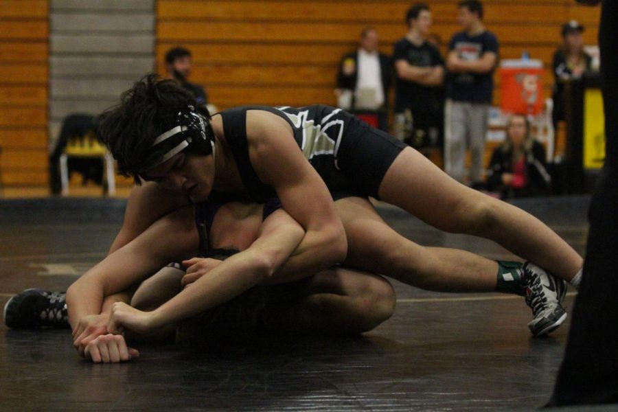 T.J. Condren takes down opponent from Rock Bridge High School in the Francis Howell North large gym.