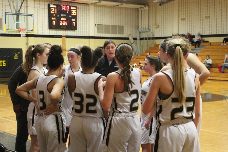 The JV Lady Knights girls basketball team huddles up during a stoppage of play on 1/16 vs. Timberland.