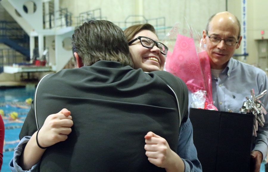 Senior Anna Linquist embraces her coach on senior night after getting her gifts.