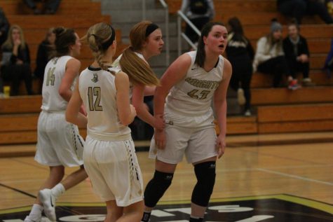 The Lady Knights varsity basketball team huddles up at half court during their home game vs. Timberland on 1/16.