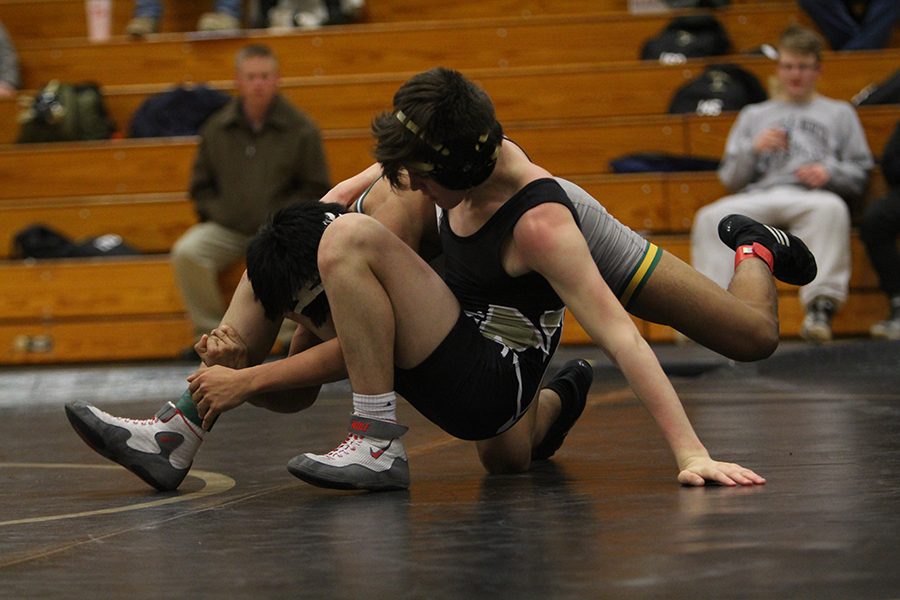 Sophomore Taylor Godfrey works to pin a wrestler on Fort Zumwalt North. 