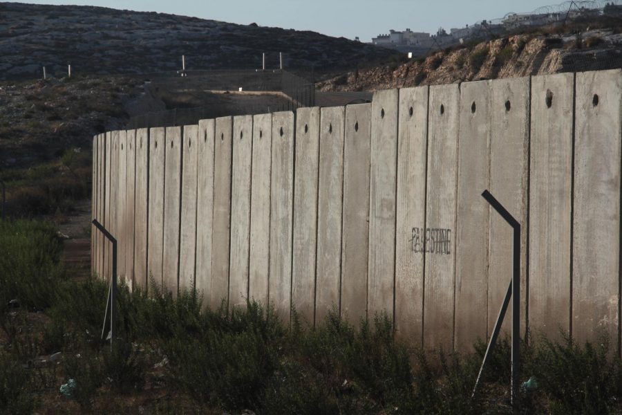 A section of the concrete Israeli West Bank barrier wall, with the world "Palestine" written on it, viewed from West Bank, Palestine. 