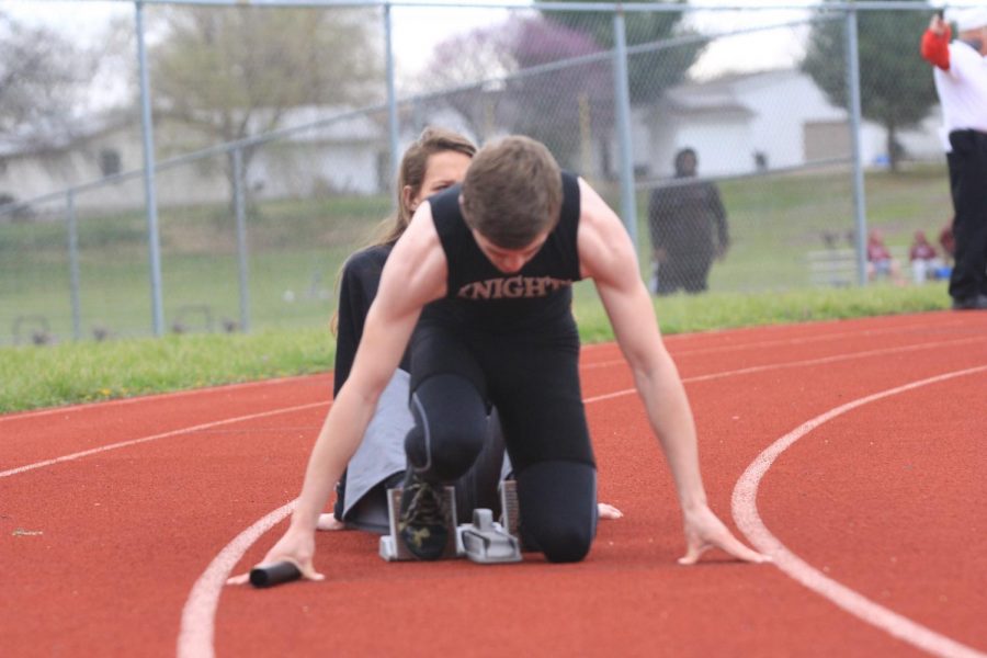 Sprinter for FHN boys track and field sets up for a race.