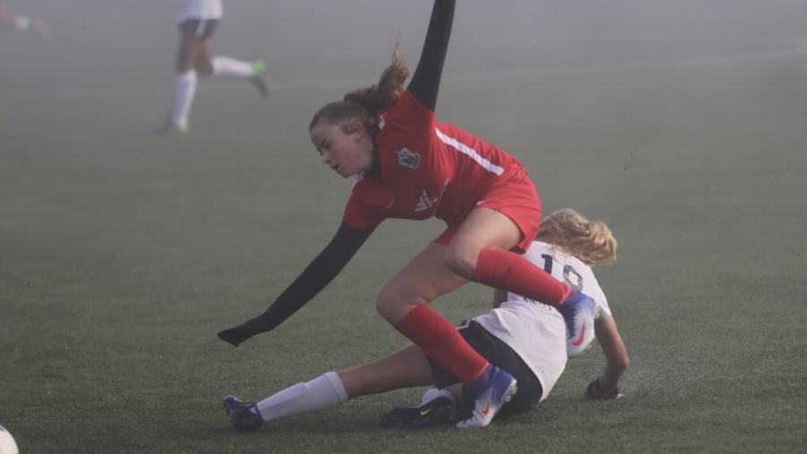 Freshman Julia Kristensen slides in on an attacker in a club match.