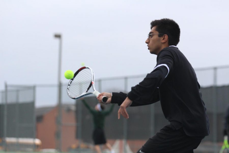 Senior Sachin Milli returns a serve in a varsity tennis match on  3/31 vs. FZN.