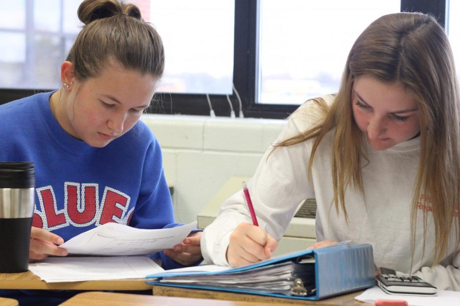 Junior Maddie Battles  (right) works on homework during homeroom. At the beginning of the year, everyone was assigned a homeroom based on their last name and grade.
Homeroom allows students to work on homework and study for test and quizzes on
collaboration days.