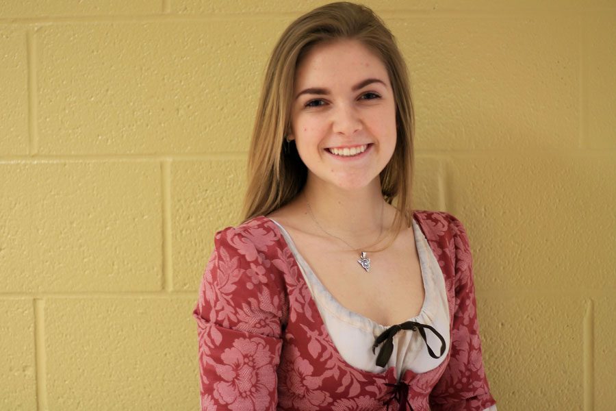 Junior Lily St. John poses in her French and Indian War Reenactment outfit. “The only thing I would want to change about the reenactments is the time. I want it to last longer,” Lily said.