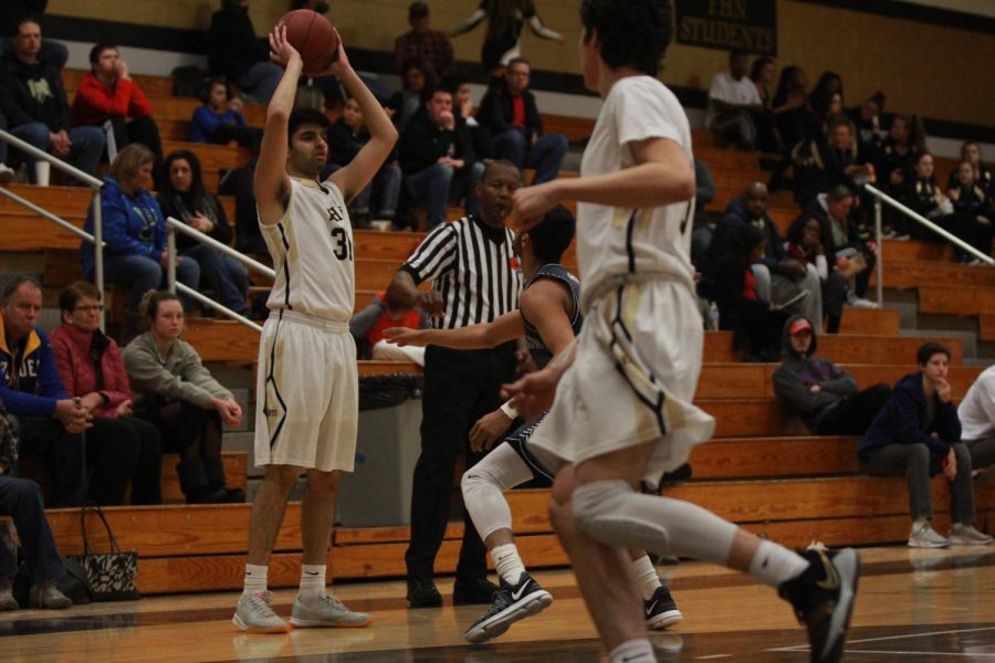 Senior Rizwan Hyder looks to pass during the Jan. 16 game against Timberland. The Knights won with a final score of 80-75.