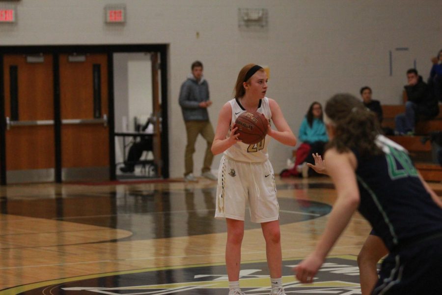 Freshman Isabelle Delarue looks to pass during the varsity game against Timberland on Jan 16.. Delarue is the only freshman on the varsity girls’ basketball team and plays alongside her sister junior Gabby Delarue. Isabelle has scored 220 points during her first season on the team.