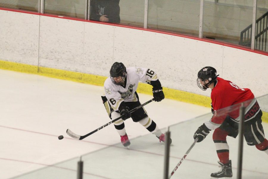 Senior Matthew Tilley skates around an opponent from FZS during the varsity hockey match on Nov. 10. The Knights got two goals in attempt to take the lead but still lost 4-3.