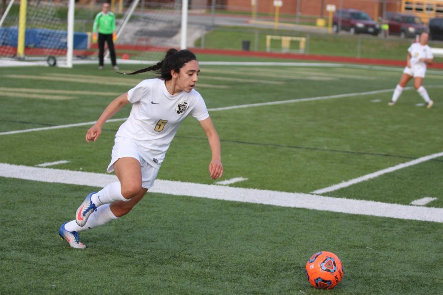 Sophomore wing back Lauren Shah prepares to knock the ball up the field in a match with FZW on 4/13.