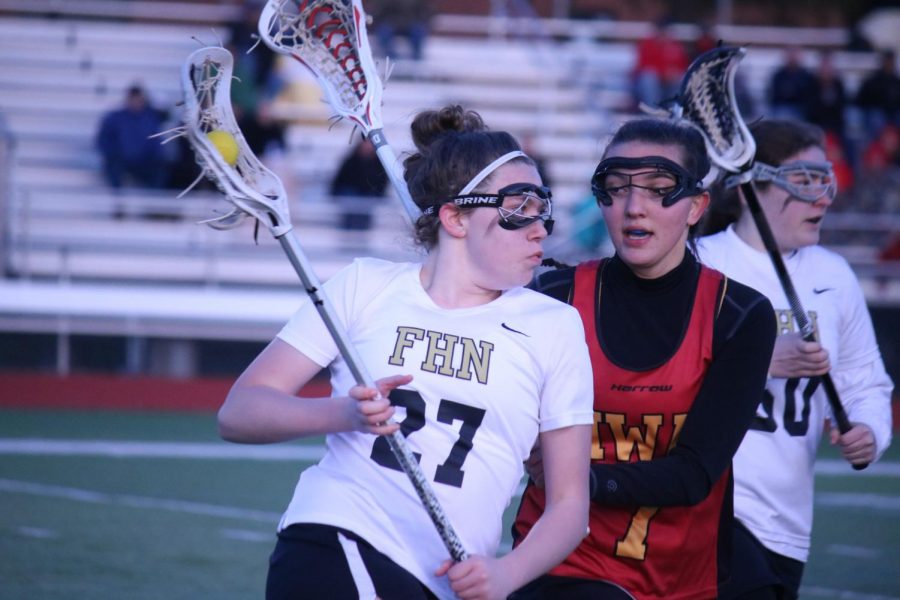 Sophomore Hailey Jenkins takes on a defender in a varsity girls lacrosse match against Incarnate Word on 4/4. 