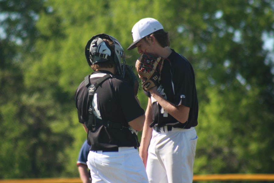 Senior Ethan Faltisek speaks to catcher during game at Fort Zumwalt West. 