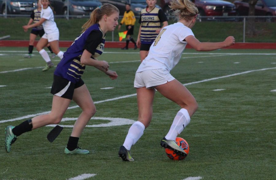 Junior Sam Cary tries to turn past the defender in a rivalry match with Troy on 3/30.