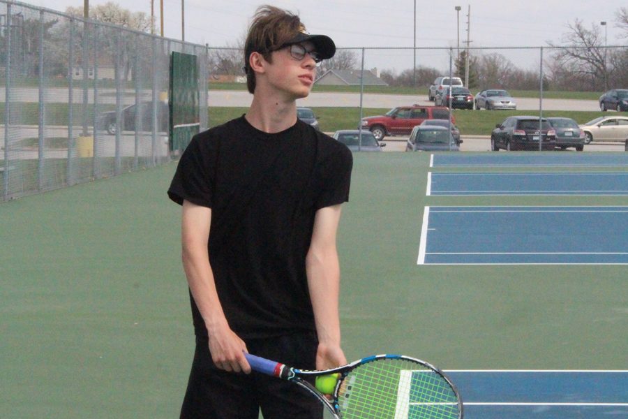 Junior Will Schellman prepares to serve the ball.