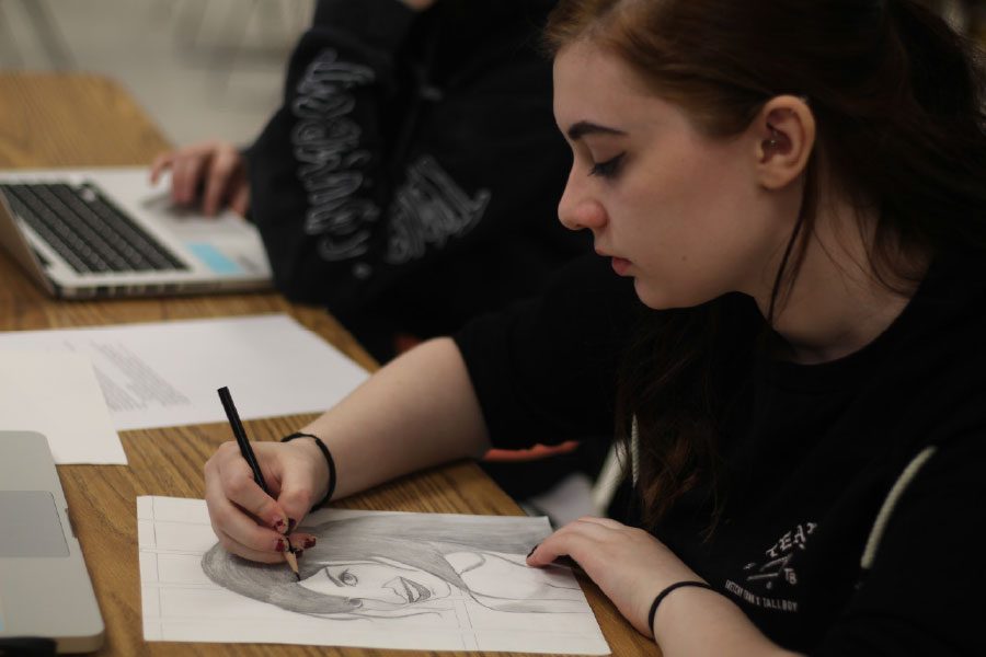 Senior Riley Kampff works on an art piece in the AP art room. The Lillian Yahn Art Gallery had an AP art exhibition for FHN and FHHS April 10-26. 