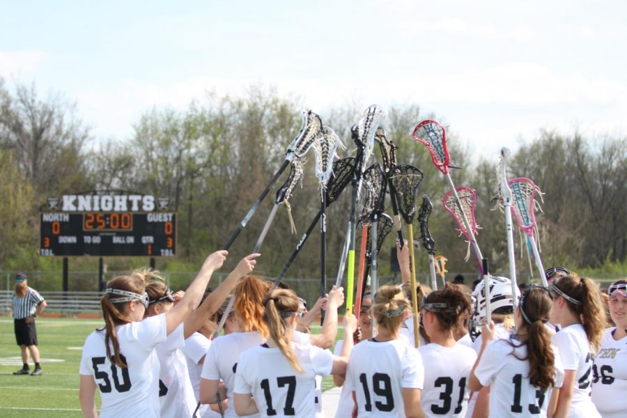 The girls lacrosse team huddles up before a game against Hazelwood East.