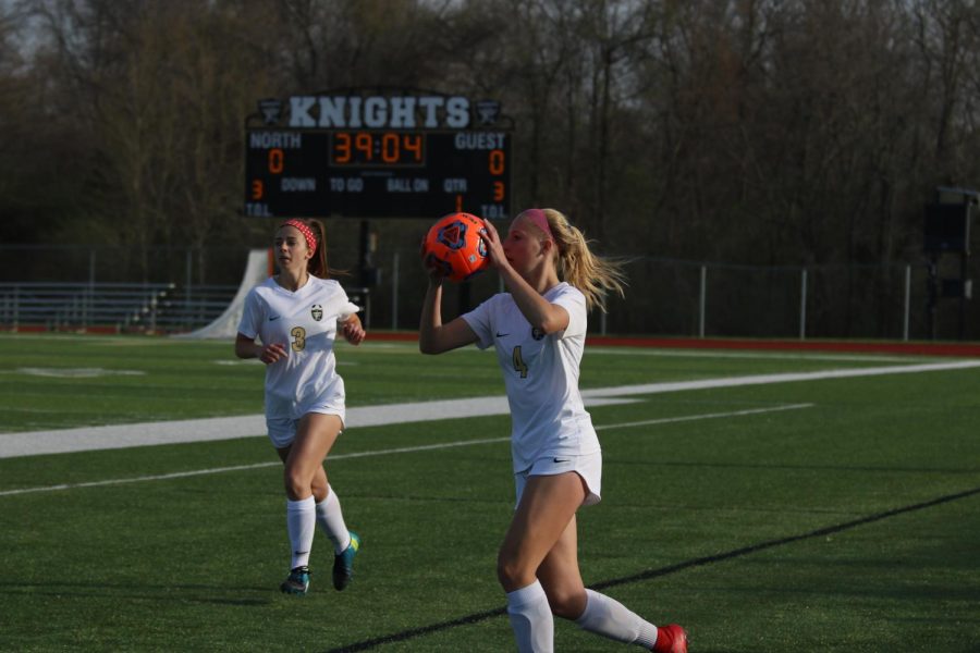 Junior Sam Cary prepares to throw the ball in for a teammate with teammate Maddy Wood in the background on 4/17 vs. Troy. 