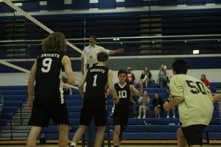 Avery Ward, Trey Dehesa, and the varsity boys volleyball team celebrates a point vs. Francis Howell on 4/5. 