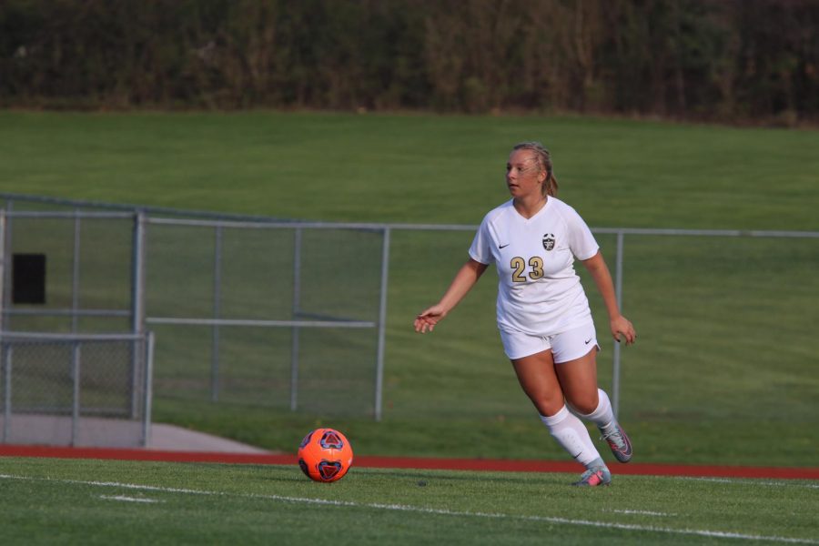 Senior Nicole Grellner prepares to knock the ball up the field vs. Troy on 4/17.