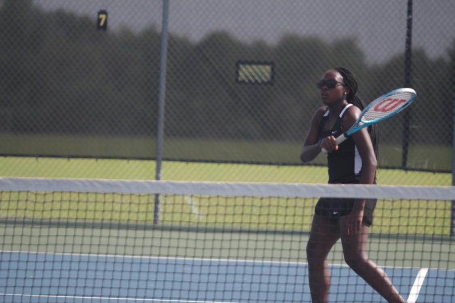 Senior Bria Hamilton hits the ball over the net during a match.