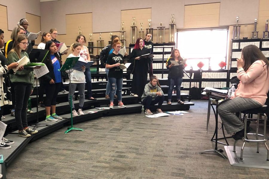 Bella Voce ladies read their music while watching Jennifer Crane for cut-offs. This choir rehearses during fifth hour everyday. Their first concert is on Nov. 20.