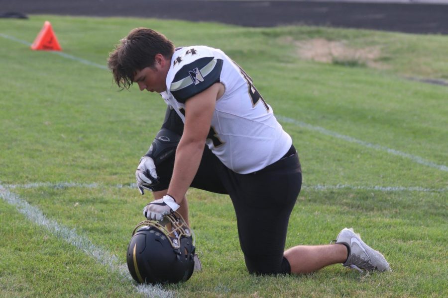 Senior Robbie O'Laughlin kneels as he prepares for his game against Ritenour