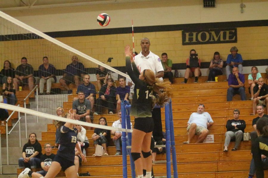 Sophomore Isabelle Delarue attempts to block the ball in a match against Holt.