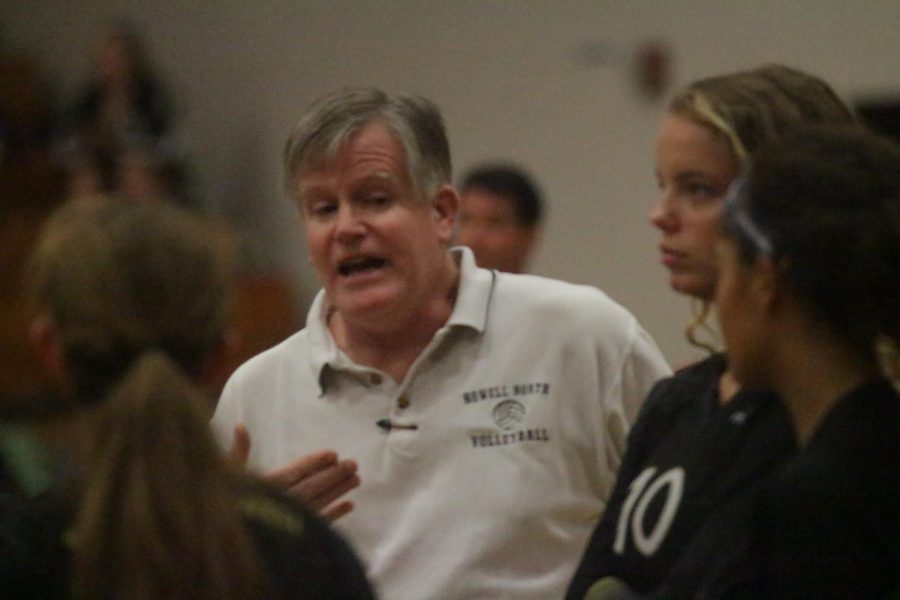 Coach Kent Stover talks to the Girls Volleyball team during a timeout.