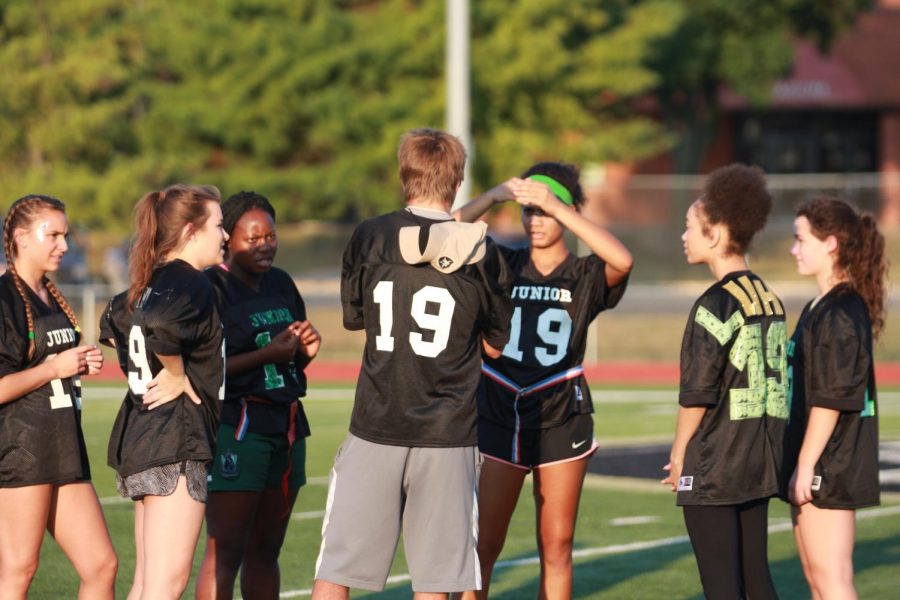 Coach Dillon Lauer plots a play with his, then, junior team. Lauer returned to coach, but this time as a senior.