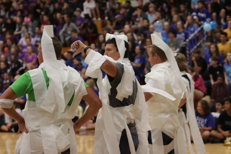 (From Left to Right) Teachers Joe Brocksmith and Timothy Besse, model with Hed Principal Dr. Nathan Hostetler at the Homecoming Pep Assembly on Sept. 14 2018