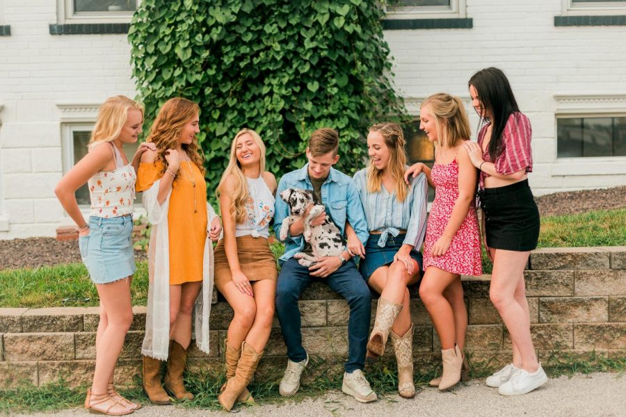 Ryanne O'Donnell's models sit talking and laughing, while model Wil Skaggs holds a dog.