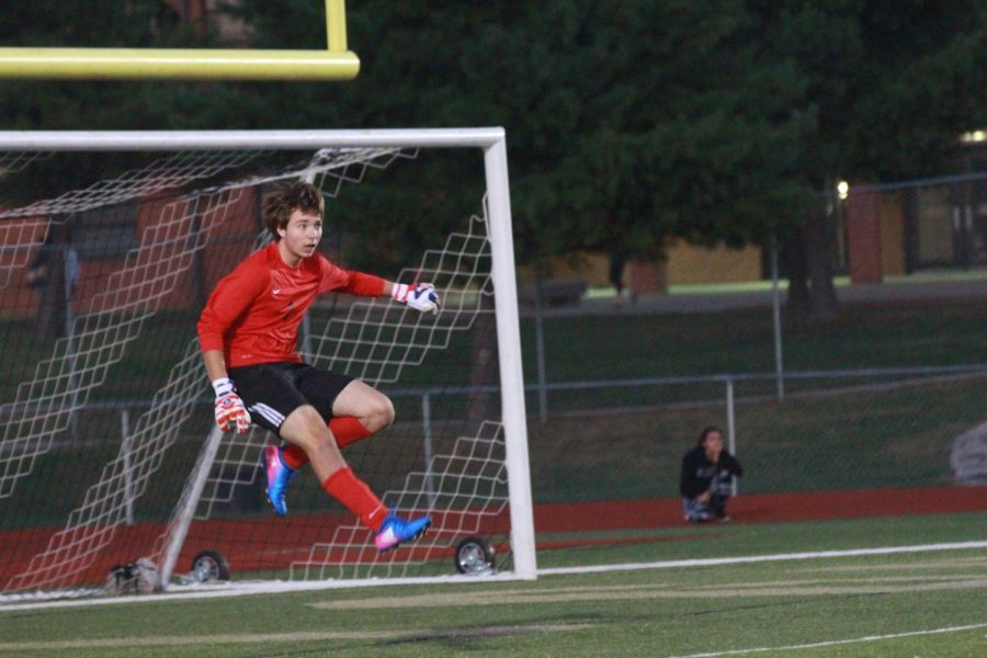 Senior Corey Valleroy kicks the ball out to his fellow players