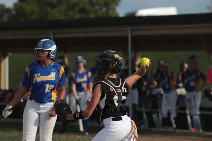 Sophomore Becka Brissete prepares to throw the ball in an attempt to throw out a runner stealing a base against FHHS.