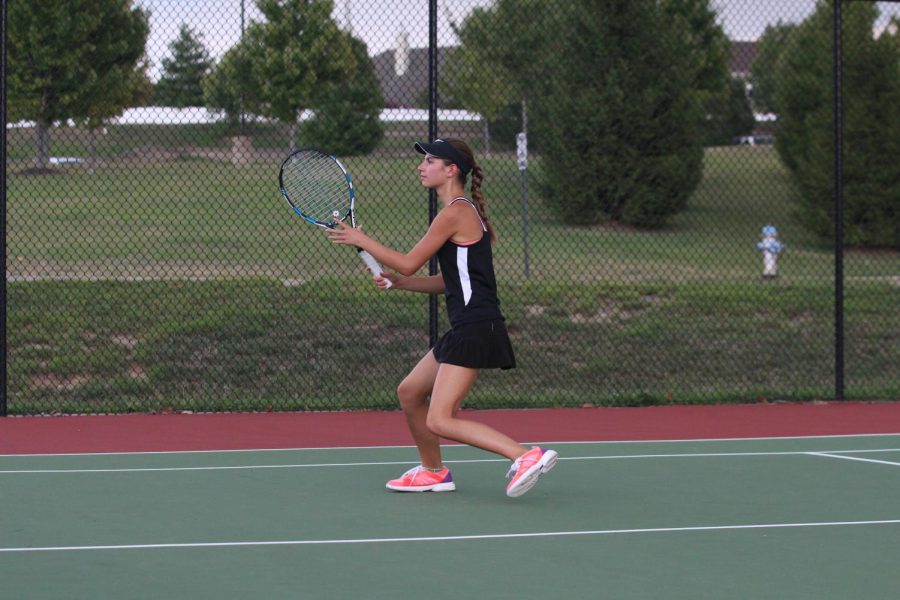 Senior Katie Prinkey prepare to hit the ball over the net during a match.