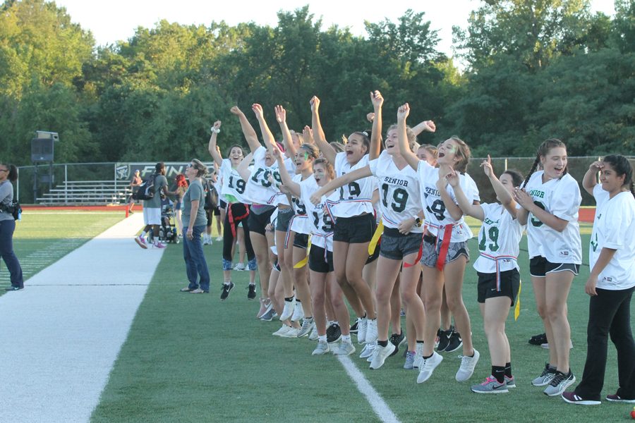 Seniors in Powderpuff cheer after their team scores another touchdown. This group of seniors have won two years in a row and beat the juniors, 126-77.